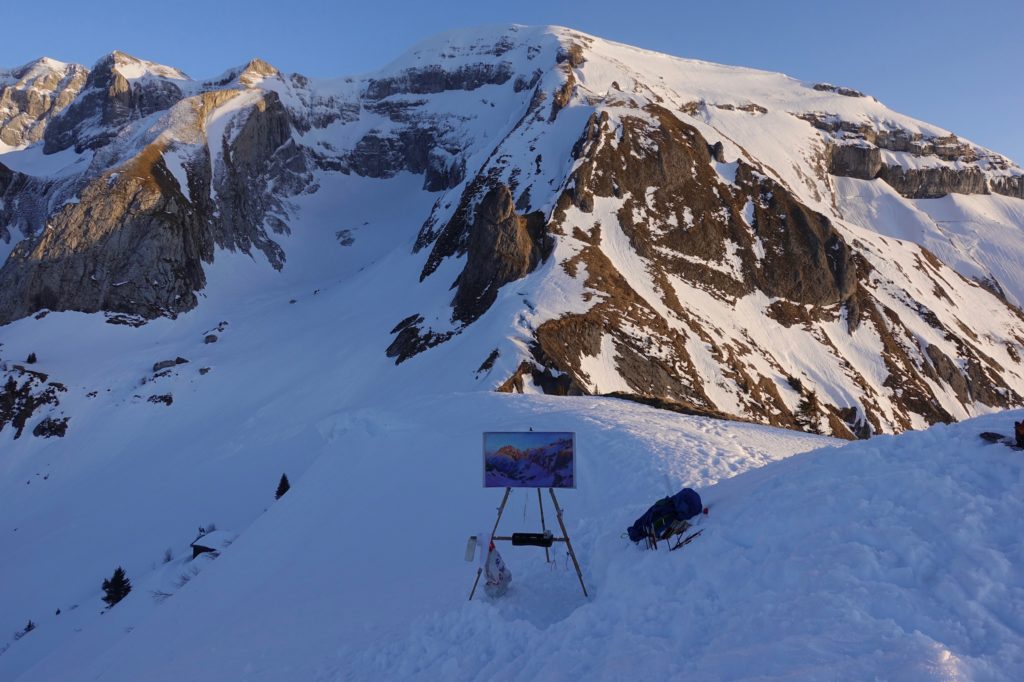 Easel set up in the snow. Painting the Dents du Midi with Sunset